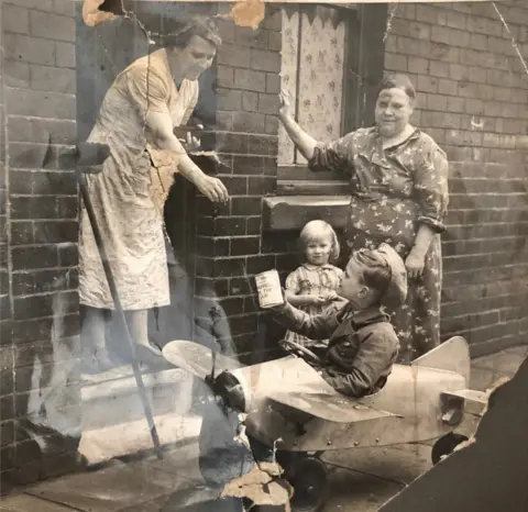 Oliver Furniss An old photograph of a young boy collecting money for the Sheffield air force during World War Two.