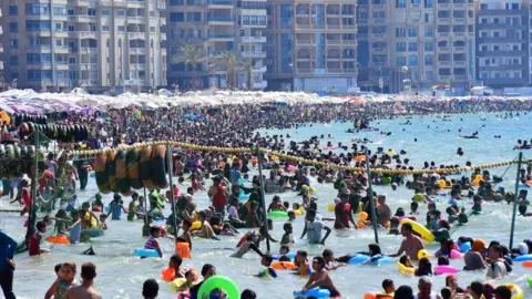 Getty Images People gather at the beach in Egypt's northern coastal city of Alexandria on July 5, 2019.