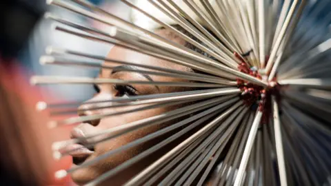 Getty Images A model presents a creation by local designers during a fashion show in Durban, on July 6, 2019.
