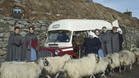 BBC Call the Midwife characters surrounded by sheep