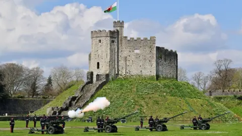 PA Media Royal Artillery fire a 41-round gun salute in the grounds of Cardiff Castle to mark the death of the Duke of Edinburgh