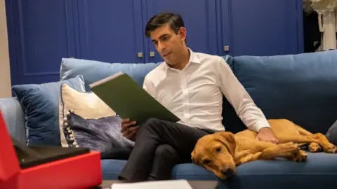 UK government Rishi Sunak with red Labrador puppy Nova
