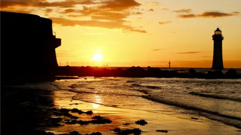 Stephen Carrigan The sun setting over New Brighton beach on the Wirral in Merseyside