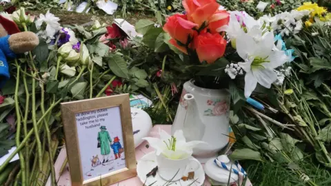 Eleanor's artwork left among floral tributes and a teapot