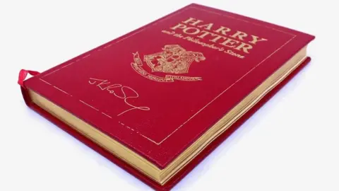 Hansons The leather-bound anniversary edition of Harry Potter and the Philosopher's Stone signed by author JK Rowling