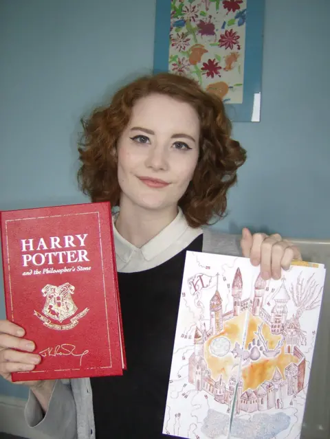 Hansons Chloe Esslemont holding the book and her colourful competition letter