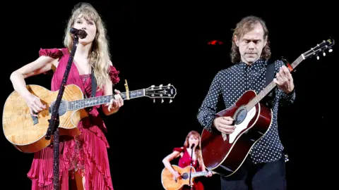 Getty Images Taylor Swift and Aaron Dessner perform onstage during "Taylor Swift | The Eras Tour" at Raymond James Stadium on April 14, 2023 in Tampa, Florida