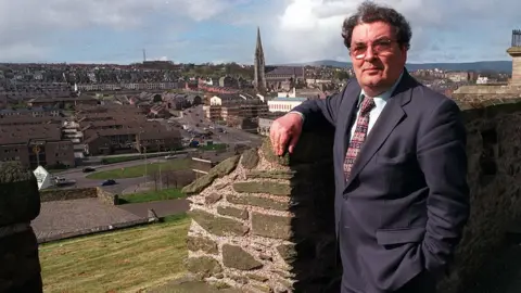 PAcemaker John Hume, founder and former leader of the SDLP, pictured on the walls of his home city
