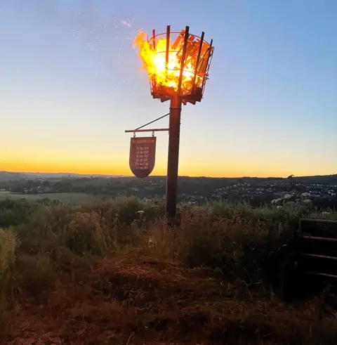 Amanda Lucas A lit beacon marking the Queen's Platinum Jubilee in Kingsbridge, Devon