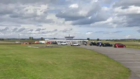 Google The present day control tower with cars parked nearby